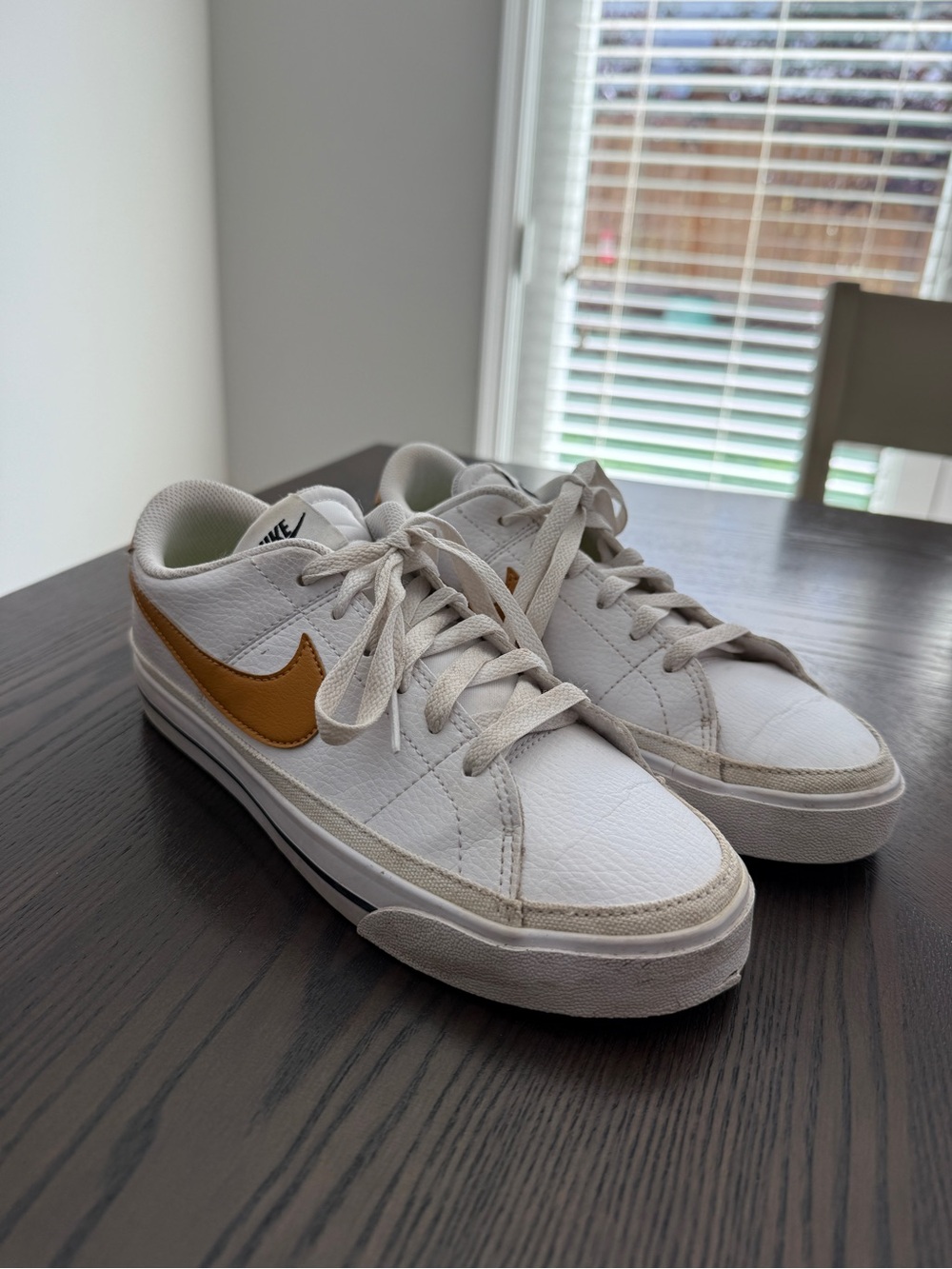 Nike White Sneakers with Gold Swoosh Accent